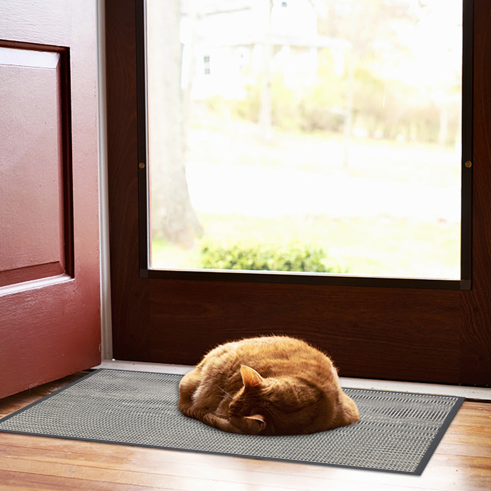 A cat lies on Matace's indoor door mats.