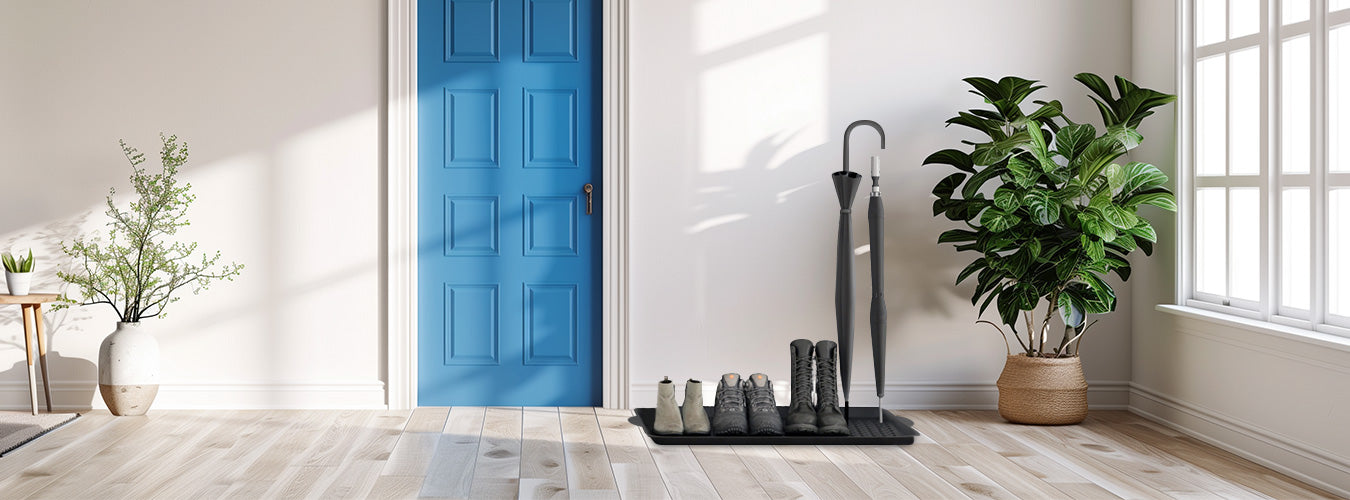 In a simple style home, a Matace shoe tray is lined with pairs of shoes in the doorway.